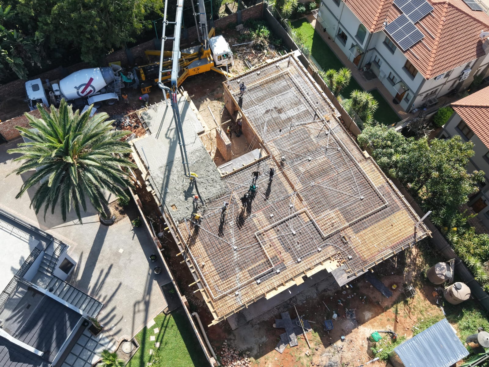 Aerial Drone View of Reinforced Concrete Slab Pour with Boom Pump